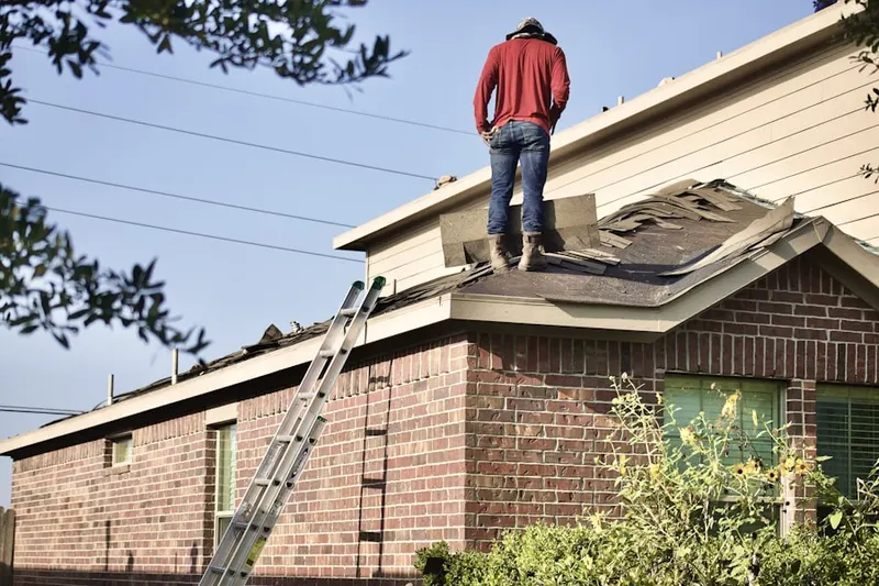 Professional roofer working on a residential roof in Old Covered Bridge Estates